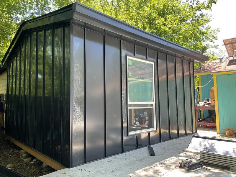 Black standing seam metal wall panels for Roof Inspection in Aston